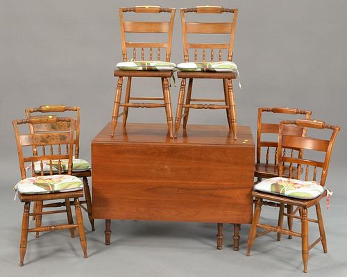 Cherry drop leaf table and six side chairs, signed Hitchcock. table: ht. 29 in.; top closed: 27" x 42", top open: 68" x 42"