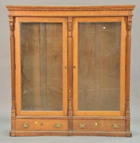 Victorian oak two door bookcase with two drawer base. ht. 65 1/2 in.; wd. 62 1/2 in.