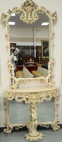 Italian carved marble top hall table and mirror having elaborately carved mirror over half round hall table having putti center leg....