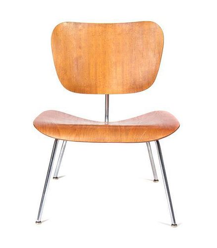 * A Charles and Ray Eames Walnut DCM Chair, Height 27 inches.