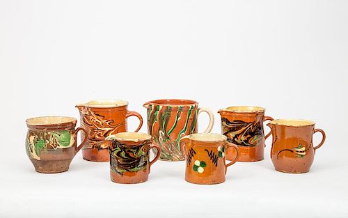 Seven French Orange-Glazed Pottery Pitchers