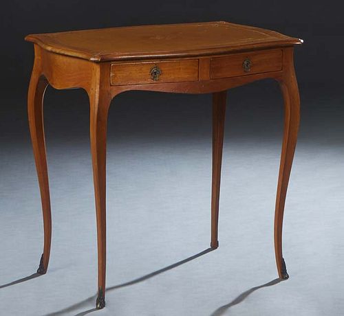 French Louis XV Style Carved Walnut Writing Table, 20th c., the tortoise top with an inset gilt tooled tan leather writing surface, on cabriole legs w