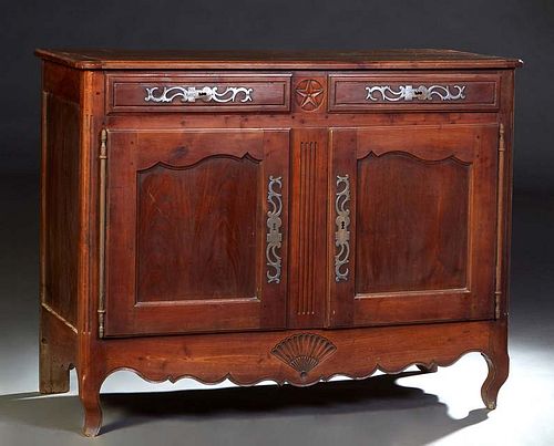 French Provincial Louis XV Style Carved Walnut Sideboard, early 19th c., the ogee edge rounded corner top over two frieze drawers with iron escutcheon