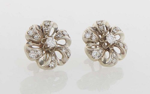 Pair of 14K White Gold Screwback Earrings, 20th c., of floriform, with a center 15 point round diamond, flanked by six pierced "leaves," each mounted 