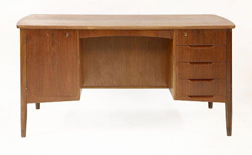 A Danish teak desk,<BR>with a cupboard and drawers to the front, and two shelves to the reverse,<BR>