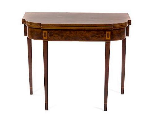A Sheraton Style Mahogany Flip-Top Games Table, Height 29 3/4 x width 17 7/8 x depth 35 3/4 inches.