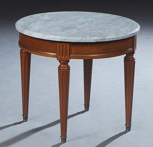 French Louis XVI Style Ormolu Mounted Marble Top Lamp Table, 20th c., the ogee edge figured circular gray marble over a wide skirt, on four tapered re