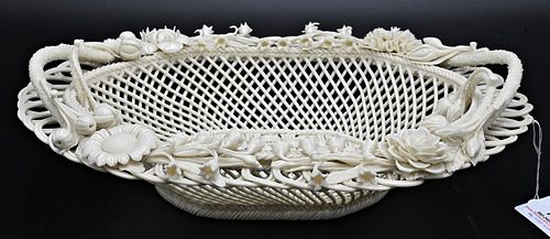 Belleek Porcelain Handled Basket, four strand, having flowers with twig handles, impressed mark on bottom, length 12 inches. Provenance: Collections o