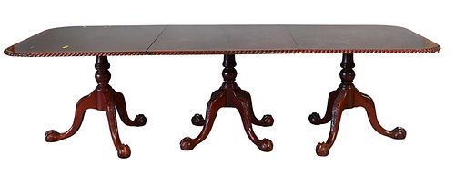 Reproduction Mahogany Triple Pedestal Dining Table, having rope edge top over carved pedestals with ball and claw feet, having two 20 inch leaves, lat