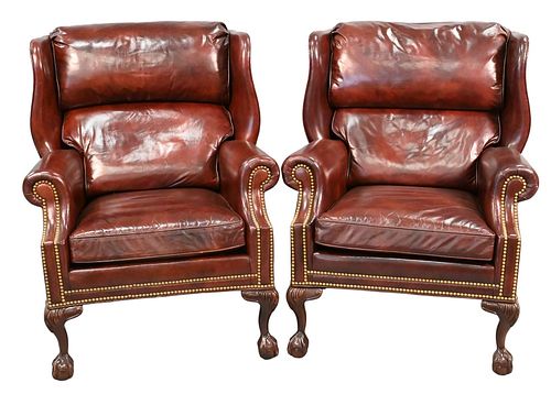 Pair of Hancock & Moore Chippendale Style Leather Upholstered Wing Chairs, having ball and claw feet, height 39 1/2 inches, width 33 1/2 inches.