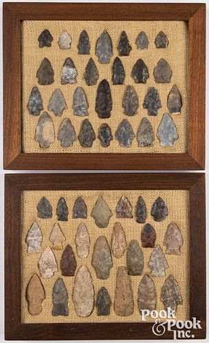 Two wood frames containing flint points