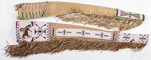 Two Plains Indian hide rifle scabbards, 20th c.