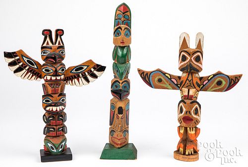 Three Alaskan Indian carved painted totem poles