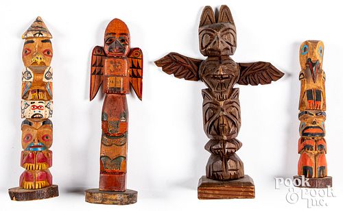 Four Pacific Northwest Indian carved totem poles