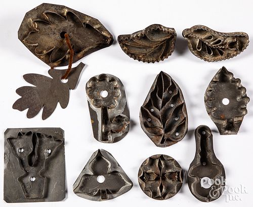 Ten tin floral and foliate cookie cutters, 19th c.
