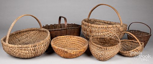 Seven assorted antique baskets.