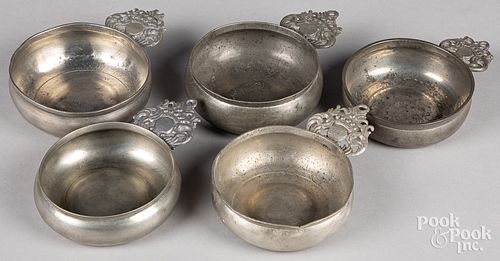 Five crown handled pewter porringers, 19th c.