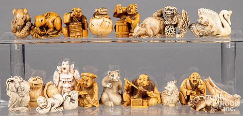 Twenty Japanese carved bone netsukes.