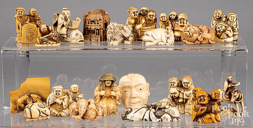 Twenty Japanese carved bone netsukes.