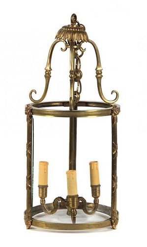 A Bronze and Glass Lantern Height 21 x diameter 9 3/4 inches.