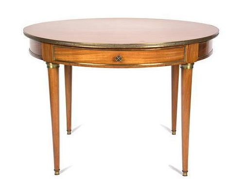 A Directoire Style Gilt Metal Mounted Fruitwood Center Table Height 29 x diameter 42 inches.