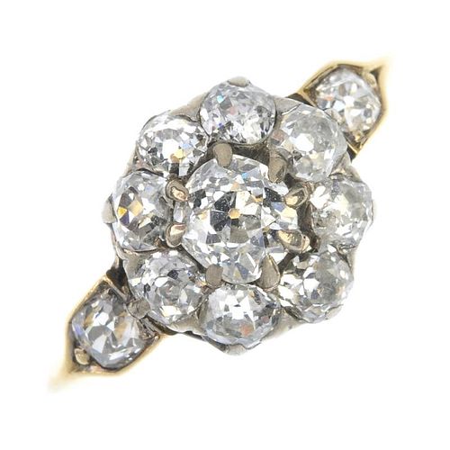 A mid 20th century gold diamond cluster ring. The old-cut diamond cluster, to the similarly-cut diam