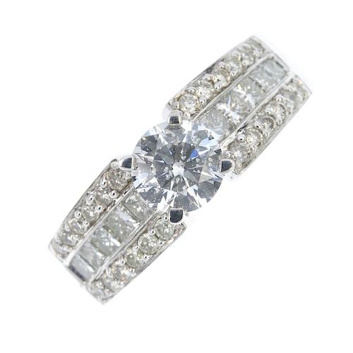 An 18ct gold diamond single-stone ring. The brilliant-cut diamond, to the similarly-cut and square-s