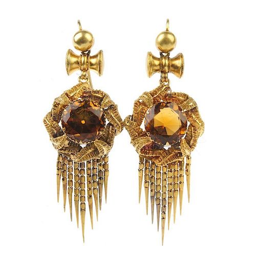 A pair of citrine ear pendants. Each designed as a circular-shape citrine, with entwined foliate sur