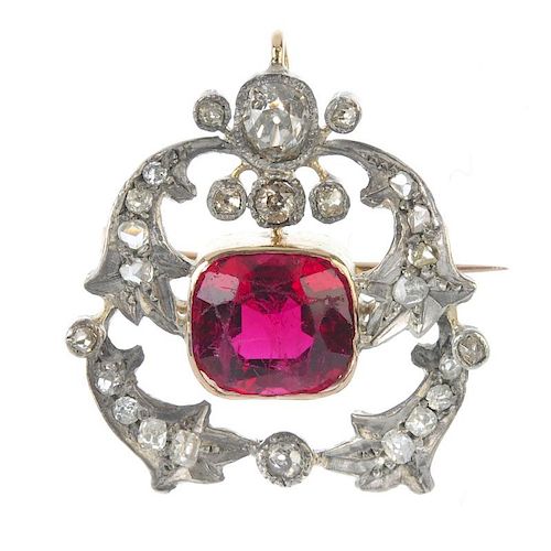 A late 19th century silver and gold, tourmaline and diamond brooch. The cushion-shape pinkish-red to