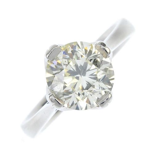 A platinum diamond single-stone ring. The brilliant-cut diamond, weighing 2.55cts, to the tapered sh