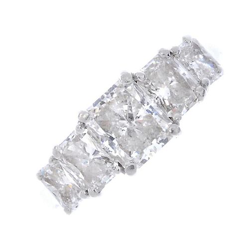 A platinum diamond five-stone ring. The rectangular brilliant-cut diamond, weighing 1.02cts, with gr
