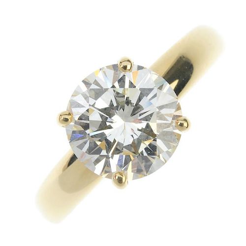 An 18ct gold diamond single-stone ring. The brilliant-cut diamond, weighing 3.44cts, to the tapered