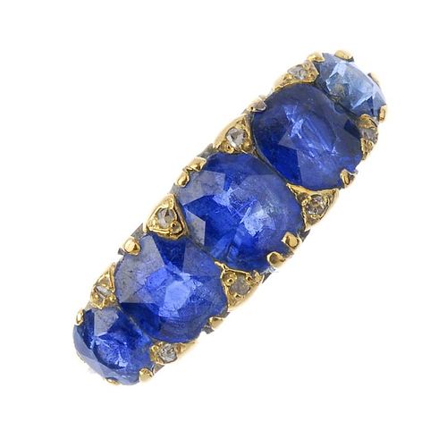 A sapphire and diamond five-stone ring. The oval-shape sapphire graduated line, between diamond poin