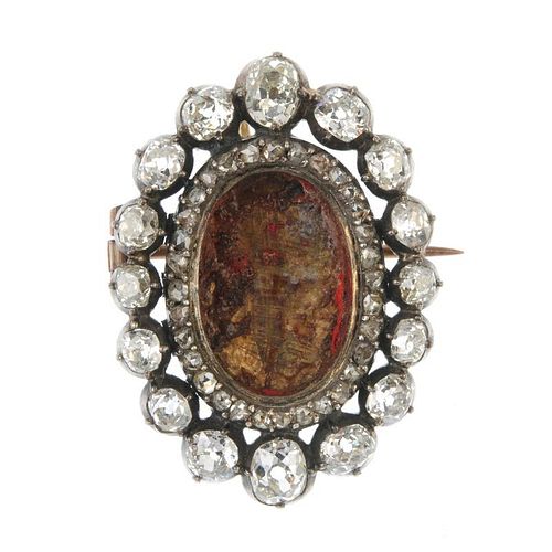 An early 19th century diamond brooch mount. The oval-shape void central panel, within a rose-cut dia