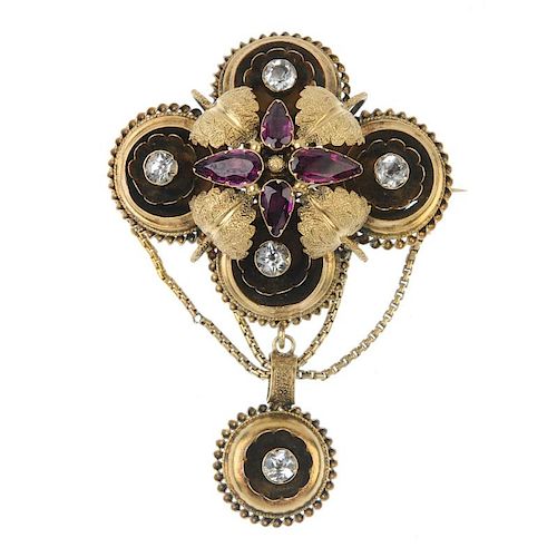 A mid 19th century gold, garnet and paste brooch. The pear-shape garnet and textured foliate cluster