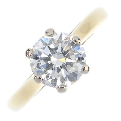A diamond single-stone ring. The brilliant-cut diamond, to the tapered shoulders and plain band. Acc
