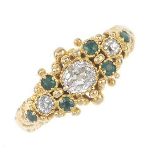 An emerald and diamond dress ring. The old-cut diamond, with circular-shape emerald and old-cut diam