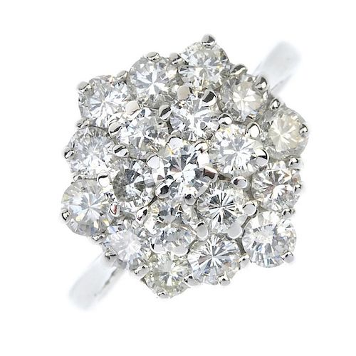 A diamond cluster ring. Designed as a brilliant-cut diamond stepped cluster, to the tapered band. Es