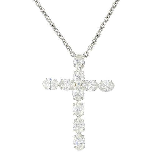A diamond cross pendant. Designed as a series of oval-shape diamonds, suspended from a belcher-link