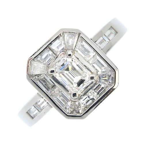 A platinum diamond cluster ring. The rectangular-shape diamond, within a tapered baguette-cut diamon