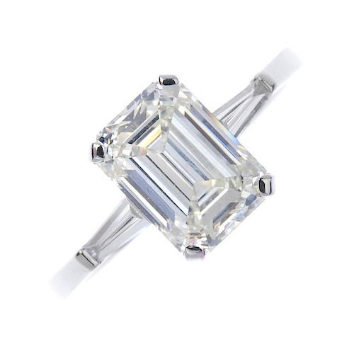 * A diamond single-stone ring. The rectangular-shape diamond, with tapered baguette diamond sides, t