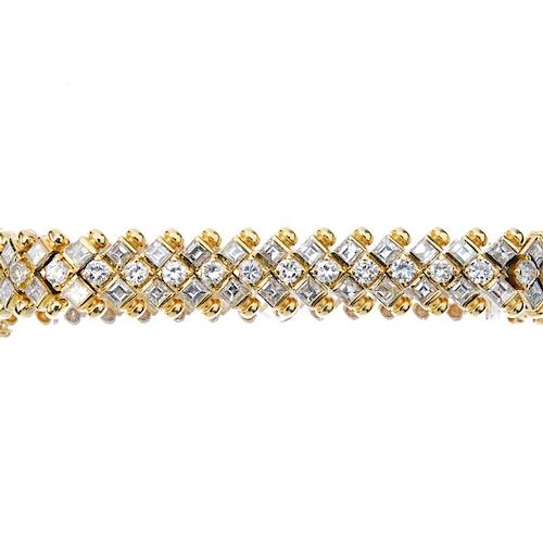 A diamond bracelet. Comprising a brilliant-cut diamond line, with square-shape diamond double spacer