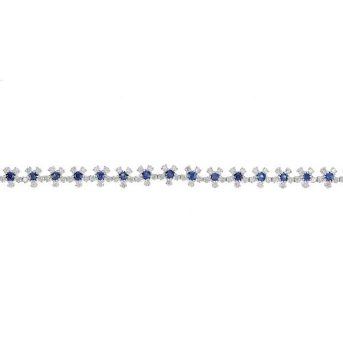 A sapphire and diamond floral bracelet. Designed as a series of circular-shape sapphire and brillian