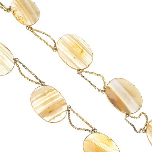 An early 19th century gold agate necklace. Designed as a series of banded agate panels, with fancy-l