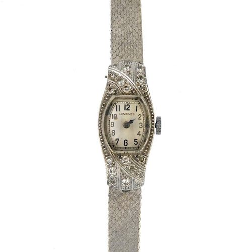 LONGINES - a lady's mid 20th century diamond cocktail watch. The oval-shape cream dial, with black A