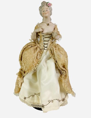 German Half Doll "Arms Away" Lady. 11 1/4" overall, porcelain half doll with molded and painted facial features, china glazed hair with applied flower