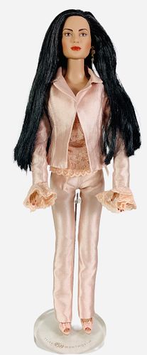 16" Tonner doll dressed in satin pink pant suit and pink shoes. Red dots on right sleeve. No box.