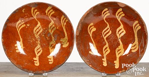 Pair of Pennsylvania redware chargers, 19th c.