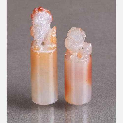 Two Chinese Carved Agate Chop Forms Depicting Seated Lions,