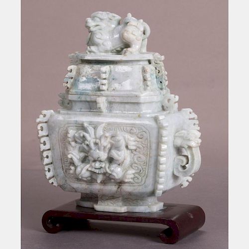 A Chinese Carved Celadon Nephrite Covered Vessel on a Carved Hardwood Stand.